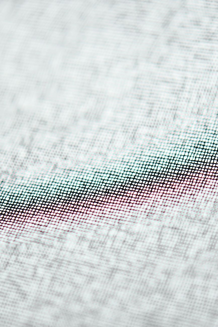 A macro-scale view of a jacquard-woven cotton textile — the specific weave interlock a heritage linen file exists to make legible.