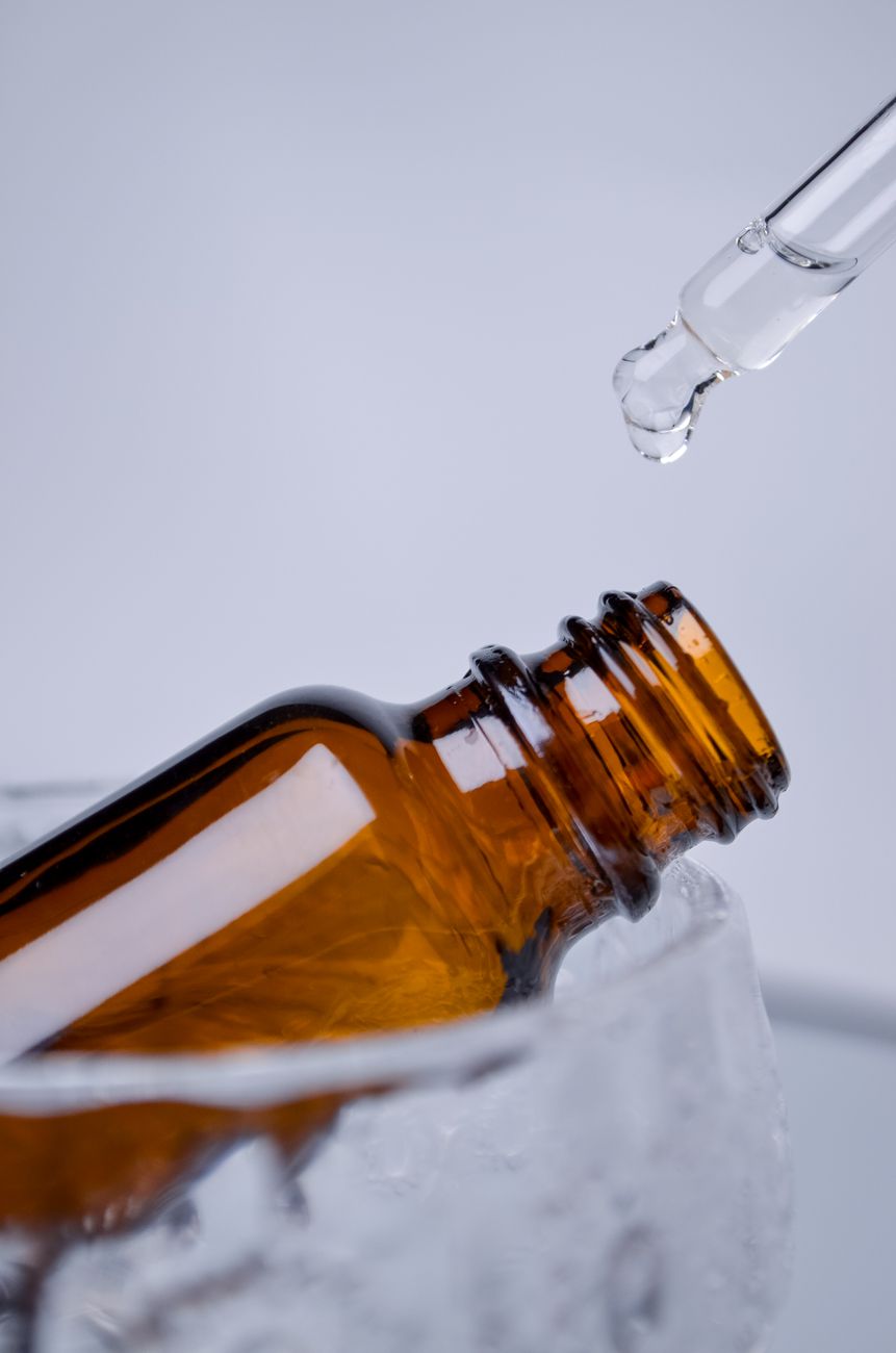 A dropper releasing serum from an amber bottle — the moment where a claimed 10% active concentration becomes a measurable dose on skin.